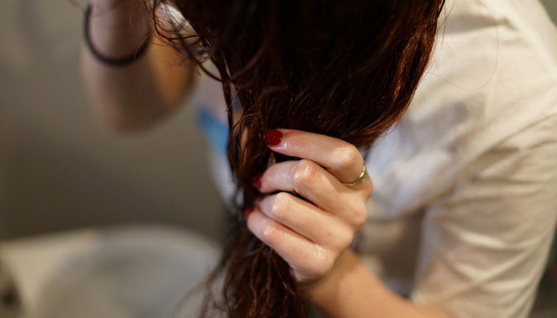 woman takes care of her hair