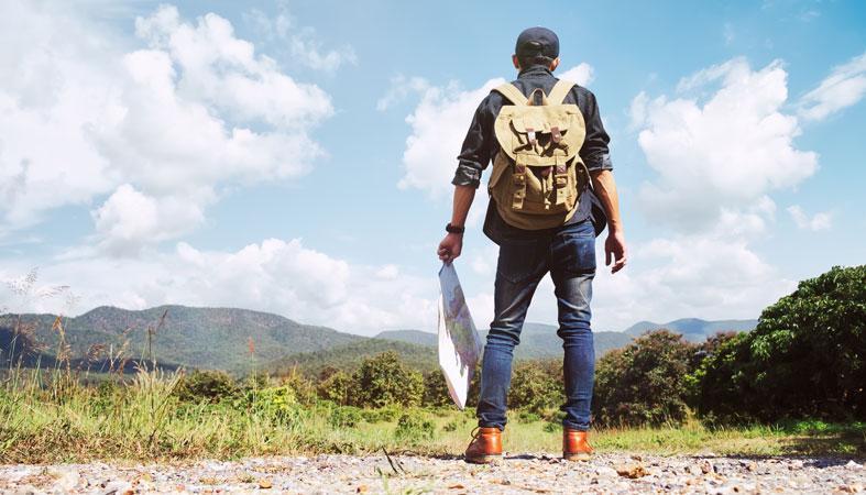 young man traveler with backpack relaxing outdoor