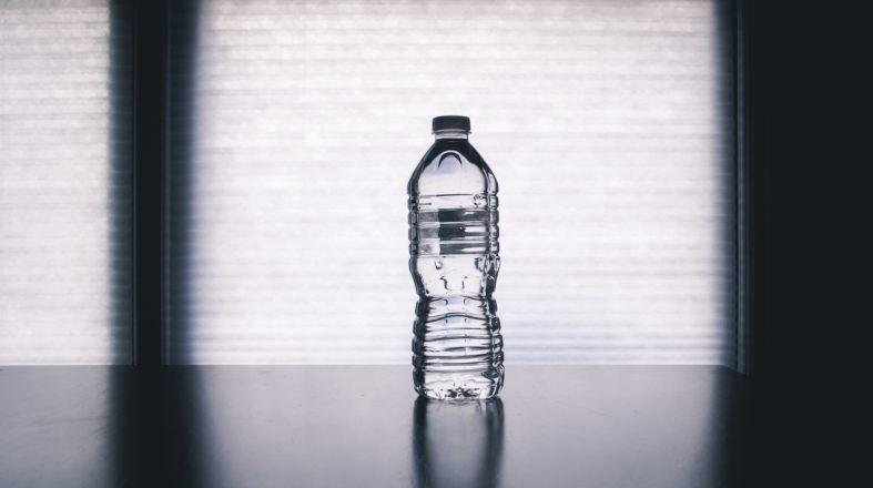 photo of bottle of the water on the dark table