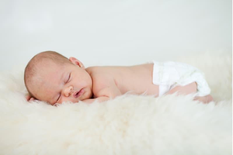 adorable baby infant sleeping on stomach with butt in the air