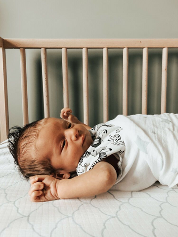 baby stretching out of swaddle 