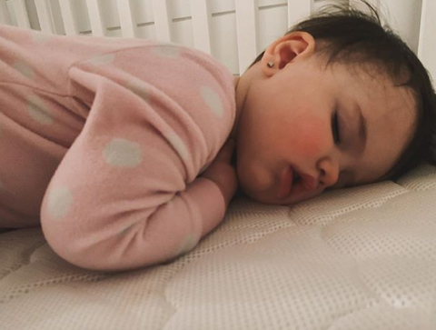 up-close of baby sleeping on stomach